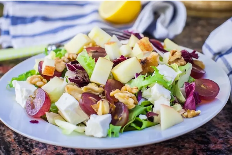 Salad with cheese, fruits, and herbs